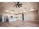 Spacious living room view with modern lighting and a connected open floorplan layout next to the kitchen at 21165 W Carver Rd, Buckeye, AZ 85326