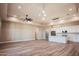 Expansive open floor plan with modern kitchen, stainless appliances, and spacious living area with wood-look floors at 21165 W Carver Rd, Buckeye, AZ 85326