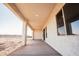 Covered porch with stucco columns and an open view at 21165 W Carver Rd, Buckeye, AZ 85326