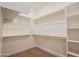 Spacious walk-in closet with wooden rods and shelving, offering ample storage space for clothes and accessories at 21165 W Carver Rd, Buckeye, AZ 85326