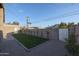 Landscaped backyard with grassy area, gravel pathway, and block wall at 2329 E Turney Ave, Phoenix, AZ 85016