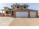 Two-story house with a brick facade, three-car garage, and landscaped front yard at 8934 W Ocotillo Rd, Glendale, AZ 85305