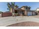 Two-story house with a brick facade, three-car garage, and gate at 8934 W Ocotillo Rd, Glendale, AZ 85305