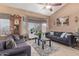 Bright living room with bay window, comfy couches, and a ceiling fan at 8934 W Ocotillo Rd, Glendale, AZ 85305