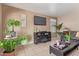 Living area with a fireplace and plenty of houseplants at 8934 W Ocotillo Rd, Glendale, AZ 85305