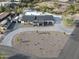 Stunning aerial view of a modern home with a pool, desert landscaping, and a circular driveway at 12524 E Saddlehorn Trl, Scottsdale, AZ 85259
