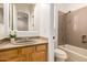Well-lit bathroom featuring a single sink vanity and a shower-over-tub, providing a functional and clean space at 14539 W Sheridan St, Goodyear, AZ 85395