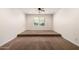 Carpeted bedroom offers neutral walls and a ceiling fan, providing a bright and comfortable space to relax at 14539 W Sheridan St, Goodyear, AZ 85395