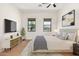 Staged bedroom with hardwood floors, modern furnishings, and decor at 14539 W Sheridan St, Goodyear, AZ 85395