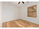 Bedroom with wood floors, ceiling fan and window with shutters at 14539 W Sheridan St, Goodyear, AZ 85395