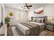 Staged bedroom featuring a bed, stylish decor and ample natural light from the window at 14539 W Sheridan St, Goodyear, AZ 85395