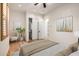 Bedroom with wood floors, closet, ceiling fan, and decorated with chair and plant at 14539 W Sheridan St, Goodyear, AZ 85395