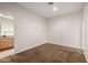 Spacious bedroom with carpeted floors, featuring a connecting bathroom, offering comfort and convenience at 14539 W Sheridan St, Goodyear, AZ 85395