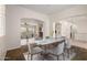 Well-lit dining space with a table set for six, seamlessly connected to the adjacent living areas at 14539 W Sheridan St, Goodyear, AZ 85395