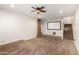 Finished home theater area with projection screen, neutral carpet and ceiling fan, ready for entertaining at 14539 W Sheridan St, Goodyear, AZ 85395