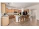 Spacious kitchen with granite counters, island seating, and ample cabinet space at 14539 W Sheridan St, Goodyear, AZ 85395