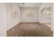 Empty living room showcasing plush carpeting and ample natural light at 14539 W Sheridan St, Goodyear, AZ 85395