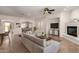 Welcoming living room with cozy sofa, fireplace, and seamless flow into adjacent dining area at 14539 W Sheridan St, Goodyear, AZ 85395