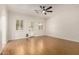 Bright, spacious living room featuring hardwood floors, neutral paint, and a modern ceiling fan at 14539 W Sheridan St, Goodyear, AZ 85395