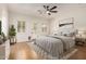 Comfortable main bedroom features light-filled windows and a ceiling fan for year-round temperature control at 14539 W Sheridan St, Goodyear, AZ 85395