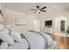 Stylishly decorated main bedroom boasts hardwood floors, neutral colors, and a comfortable layout at 14539 W Sheridan St, Goodyear, AZ 85395