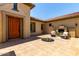 An inviting outdoor courtyard featuring a fireplace and seating area at 14539 W Sheridan St, Goodyear, AZ 85395