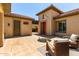 Inviting outdoor courtyard with fireplace, tiled patio, and comfortable seating at 14539 W Sheridan St, Goodyear, AZ 85395