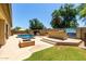 Backyard oasis with a sparkling pool, built-in barbecue, and lush landscaping for outdoor enjoyment at 14539 W Sheridan St, Goodyear, AZ 85395