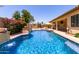 Inviting backyard with a refreshing pool, waterfall features, and ample space for relaxation at 14539 W Sheridan St, Goodyear, AZ 85395