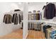 Organized walk-in closet featuring ample storage space and wooden floors at 14539 W Sheridan St, Goodyear, AZ 85395