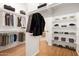 Spacious walk-in closet includes custom shelving and hanging rods for optimal organization and storage at 14539 W Sheridan St, Goodyear, AZ 85395