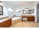 Large bathroom with double sinks, soaking tub, and separate shower at 1763 S Red Rock St, Gilbert, AZ 85295