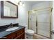 Bathroom with dark vanity and a glass-enclosed shower at 1763 S Red Rock St, Gilbert, AZ 85295