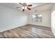 Bright bedroom with wood-look floors and ceiling fan at 1763 S Red Rock St, Gilbert, AZ 85295