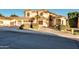 Stunning two-story home with a beige exterior, desert landscaping, and a three-car garage at 1763 S Red Rock St, Gilbert, AZ 85295