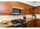 Kitchen features granite countertops and stainless steel appliances at 1763 S Red Rock St, Gilbert, AZ 85295