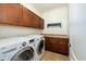 Laundry room with washer, dryer, and wood cabinets at 1763 S Red Rock St, Gilbert, AZ 85295