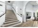 Open foyer featuring a carpeted staircase, archway, tile flooring, and ample natural light at 1763 S Red Rock St, Gilbert, AZ 85295
