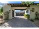 Carport entrance to motor court with brick pavers and lush landscaping at 18884 N 98Th St, Scottsdale, AZ 85255