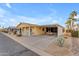 Another view of a yellow single-story home with covered parking at 2400 E Baseline Ave # 189, Apache Junction, AZ 85119