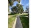 Pathway through the community with green grass and mature trees at 2687 W Ocotillo Rd, Phoenix, AZ 85017