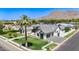 Beautiful single-Gathering home with well-maintained landscaping, lush green lawn, and modern architecture at 6040 E Lafayette Blvd, Scottsdale, AZ 85251