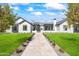 Stunning home with manicured lawn, stone pathway, and beautiful trees under a bright sky at 6040 E Lafayette Blvd, Scottsdale, AZ 85251