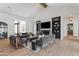 Bright living room featuring a fireplace, built-in shelving, and hardwood floors, offering a cozy and elegant living space at 6040 E Lafayette Blvd, Scottsdale, AZ 85251
