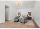 Serene main bedroom with a decorative chandelier, neutral tones, and seating area at 6040 E Lafayette Blvd, Scottsdale, AZ 85251
