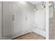 Mudroom with custom built-ins, bench seating and paneled walls at 6040 E Lafayette Blvd, Scottsdale, AZ 85251
