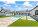 Backyard pool with a large concrete patio and artificial turf at 6040 E Lafayette Blvd, Scottsdale, AZ 85251
