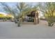 Landscaped backyard with a covered patio at 6074 E Los Reales Dr, Carefree, AZ 85377