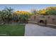 Landscaped backyard with a fountain, fire pit, and mountain views at 6074 E Los Reales Dr, Carefree, AZ 85377