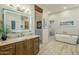Elegant bathroom with soaking tub, walk-in shower, and modern vanity at 6074 E Los Reales Dr, Carefree, AZ 85377